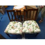 Pair of floral seated chairs with thin splats.
