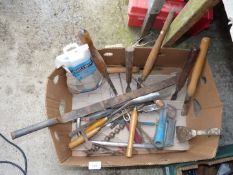 A box containing old tools including a hack saw, chisels, a lump hammer, etc.