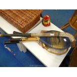 3 tennis racquets (one with press) and a hockey stick.