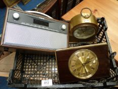 Two clocks and a Polaroid radio.