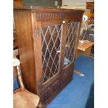 Old charm style lounge unit with leaded glazed doors and linen fold lower cupboard doors, with key,