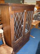 Old charm style lounge unit with leaded glazed doors and linen fold lower cupboard doors, with key,