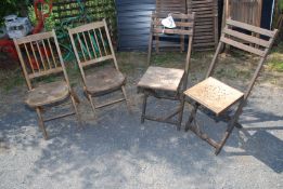 Two pairs of vintage folding chairs.