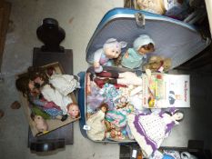 A wooden wall mounted mangle frame and suitcase of vintage dolls and jointed teddy bear.