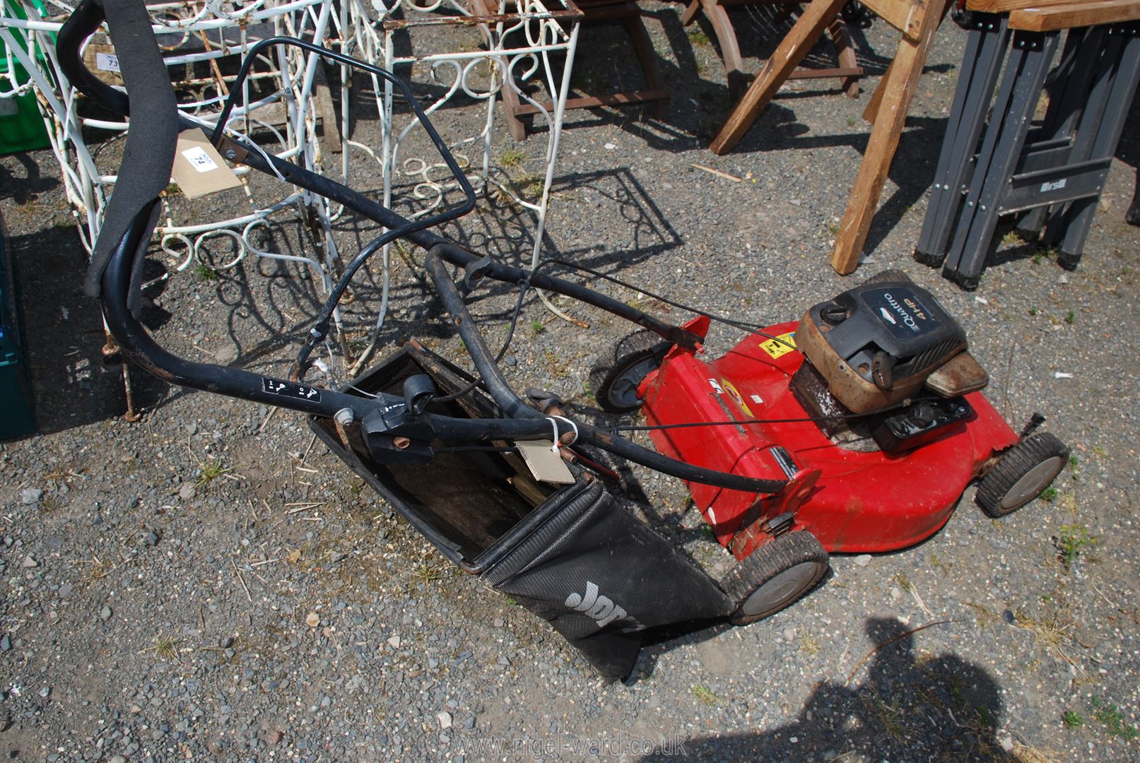 A Jonsered Boor brakes and Stratton Quattro 4HP lawn mower and bag.
