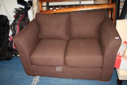 A brown two-seater sofa by Oakridge Furniture.