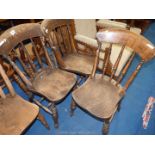 Three kitchen chairs with turned spindle backs.