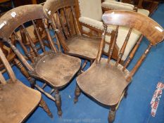 Three kitchen chairs with turned spindle backs.