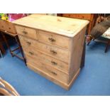 Stripped pine chest of 2 short over 3 long drawers with swan neck drop handles, one missing,