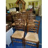 A set of 8 seagrass seated ladder back dining chairs.