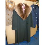 Bottle green ladies coat with sheepskin shawl collar, approx. size 16, by Ayris, Cheltenham.