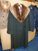 Bottle green ladies coat with sheepskin shawl collar, approx. size 16, by Ayris, Cheltenham.