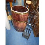 Barrel shaped umbrella stand and black metal bathroom stand.