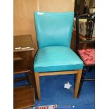 A turquoise faux leather upholstered hall chair.