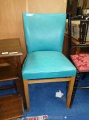 A turquoise faux leather upholstered hall chair.