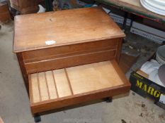 A wooden wheeled trolley with top opening and cutlery draw.