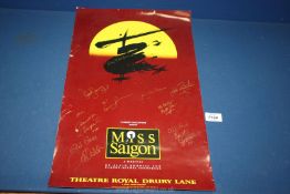 A Miss Saigon Theatre Poster signed by the cast etc. in gold ink.