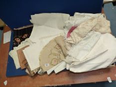 A quantity of linen including doilies, damask, leather pouch of handkerchiefs,