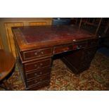 An Oak double pedestal Kneehole Desk with four drawers to the left hand side, three to the right,