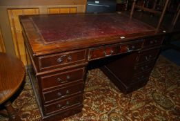 An Oak double pedestal Kneehole Desk with four drawers to the left hand side, three to the right,