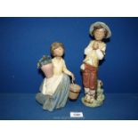 Two matt finish Nao figurines including a boy holding a bird (repaired) and a girl carrying a