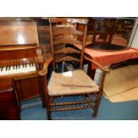 A late 19th c. Oak and rush Lancashire Armchair with ladder back bobbin turned detail.