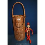 A wicker French baguette basket, 32" high overall and a doll (22" tall).