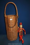 A wicker French baguette basket, 32" high overall and a doll (22" tall).