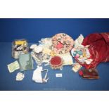 A quantity of needlework items including lace, Mother of Pearl buttons, leather sewing case,