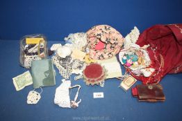 A quantity of needlework items including lace, Mother of Pearl buttons, leather sewing case,