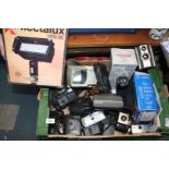 A box of cameras including a boxed Flectalux 10000 SE halogen lamp, boxed Polaroid instant camera,