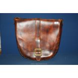 A large leather Saddlebag with brass buckle and fittings, 20" wide.