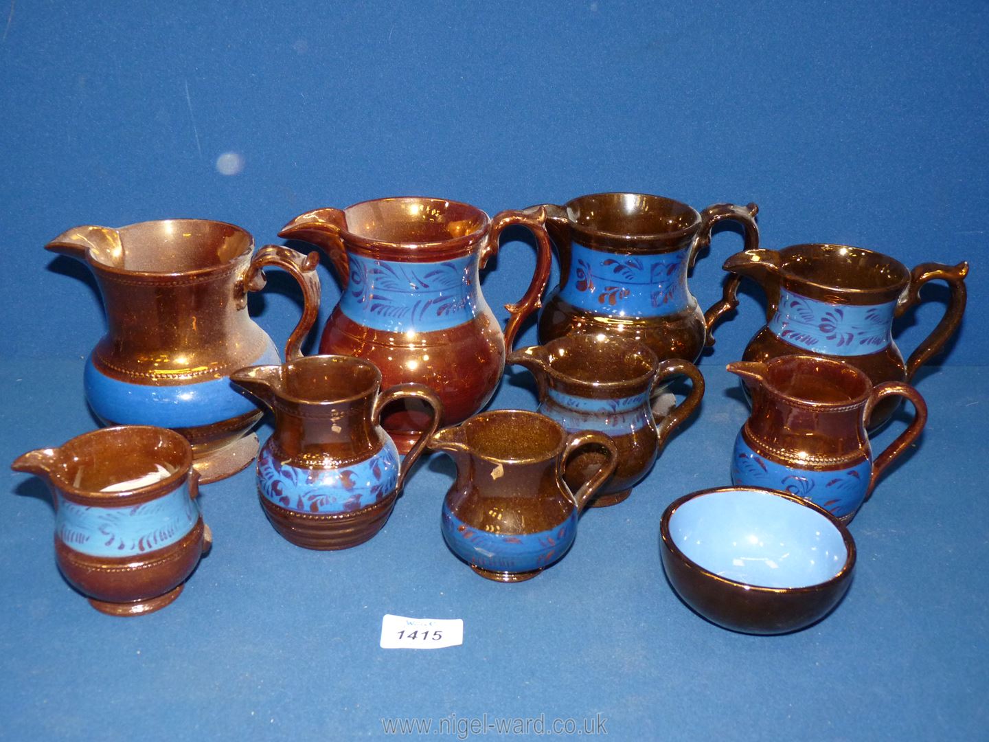 A quantity of various sized lustre jugs all with blue bands, one handle a/f,
