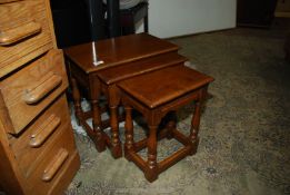 A nest of three Oak Tables standing on turned legs, the largest 19 1/8'' x 11 7/8'' x 17'' high.