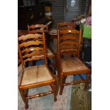 A set of four Oak framed ladder back Dining Chair having turned front legs terminating in pad feet