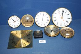 A quantity of small clock faces including quartz.