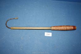 A salmon gaff, brass with wooden turned handle, 17 1/2" long.
