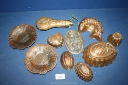 A quantity of small copper jelly moulds plus a powder flask.