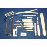 Various bone or wooden sewing/domestic accessories including a sewing clamp, needle cases,