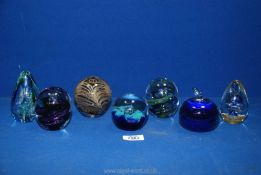 A quantity of paperweights mostly in blues to include Adrian Sankey cream and brown feather effect