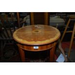 A mixed woods circular occasional table having inlaid parquetry top in contrasting colours and with