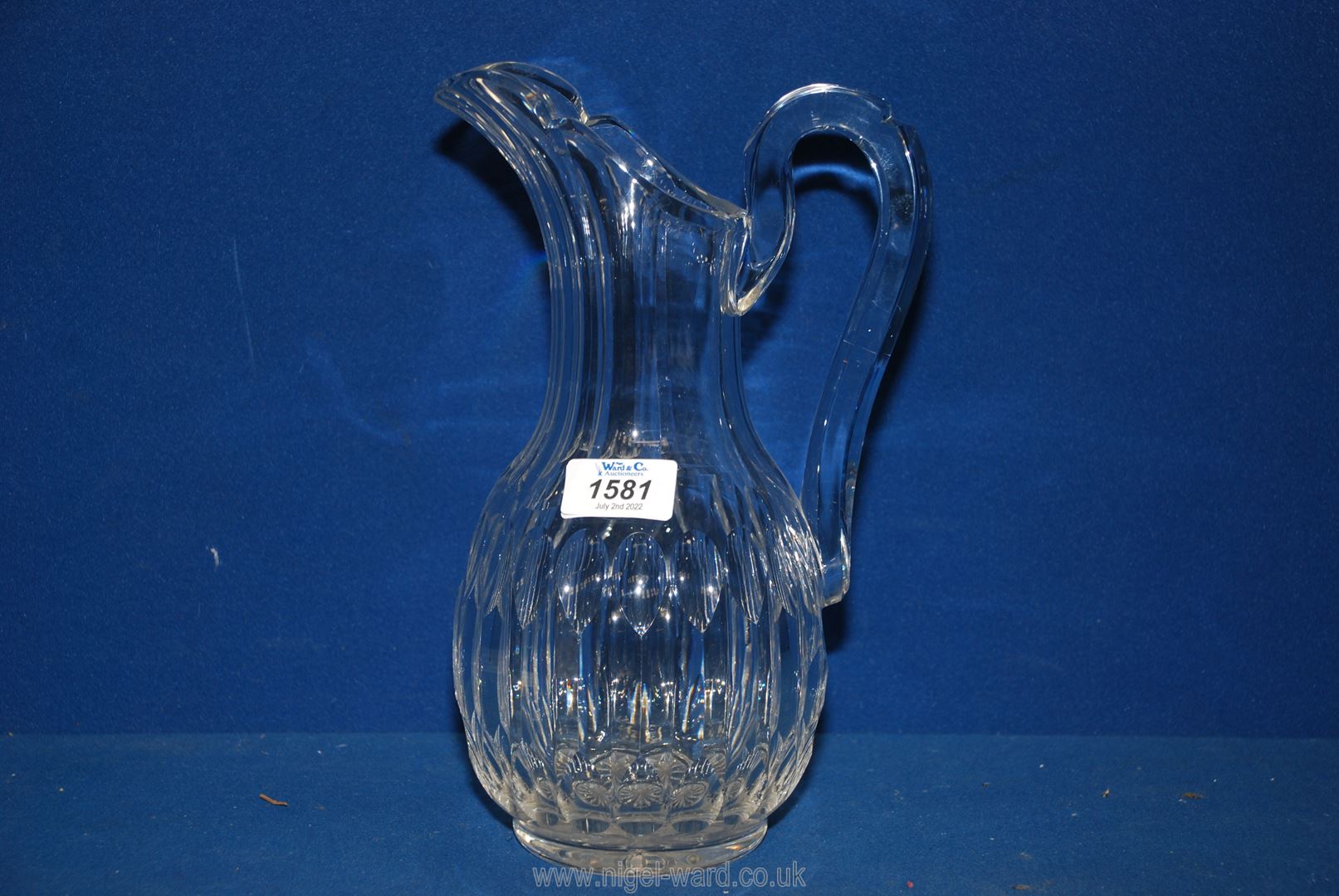 A good quality cut glass water Jug in ewer style with thumb cut detail, 11'' tall.