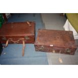 Two brown suitcases with leather straps, one Vulcan Fibre, the other initialed ADL.