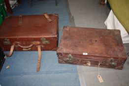 Two brown suitcases with leather straps, one Vulcan Fibre, the other initialed ADL.