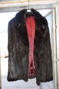 A black rabbit fur Jacket with turn down collar and side pockets, size M.