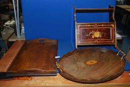 A wall mounted cupboard with shelf above with detail of musical instruments and ribbons,