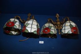 A pair of twin wall light fittings and four Tiffany style shades in cream with red flowers and