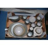 A pottery part dinner and tea service including large teapot, cups and saucers, gravy boat,