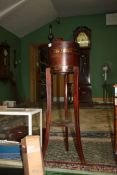 An arts and crafts Oak barrel type Planter stand by Lister having copper banding,