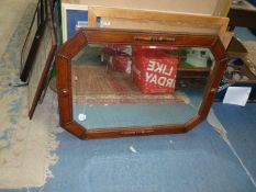 An octagonal wooden framed bevel mirror, 35" x 25".